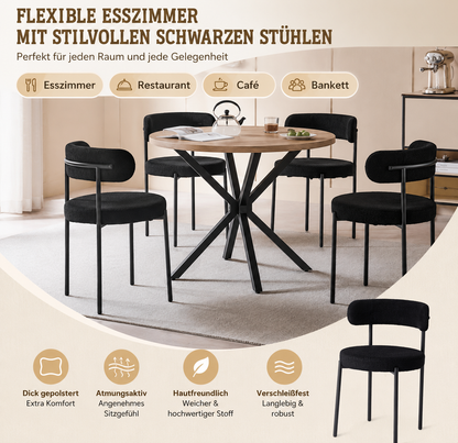 Gepolsterte Esszimmerstühle in Schwarz als moderne Sitzgruppe an einem runden Esstisch