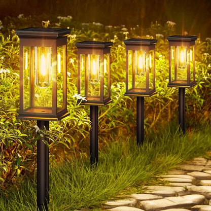 Solar LED Gartenleuchten mit warmweißem Licht entlang eines Gartenwegs